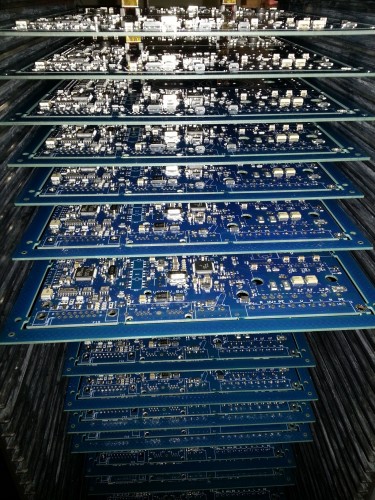 SMT assembled Argon circuit boards on a tray waiting for automatic optical inspection (AOI)